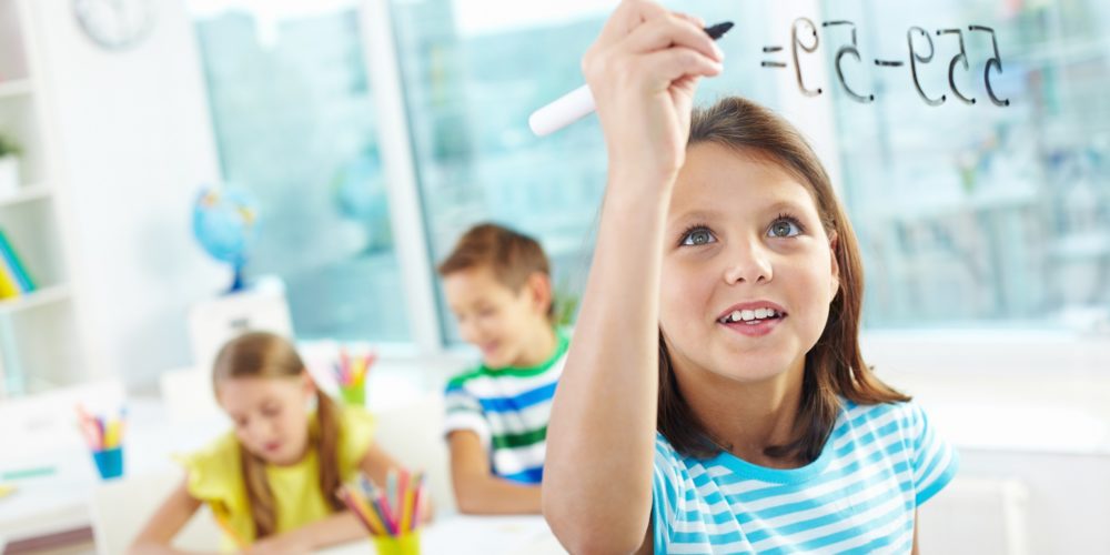 image of a girl doing calculations with more children in the background