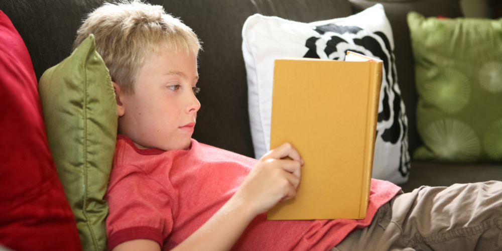 Image of a young boy reading a book