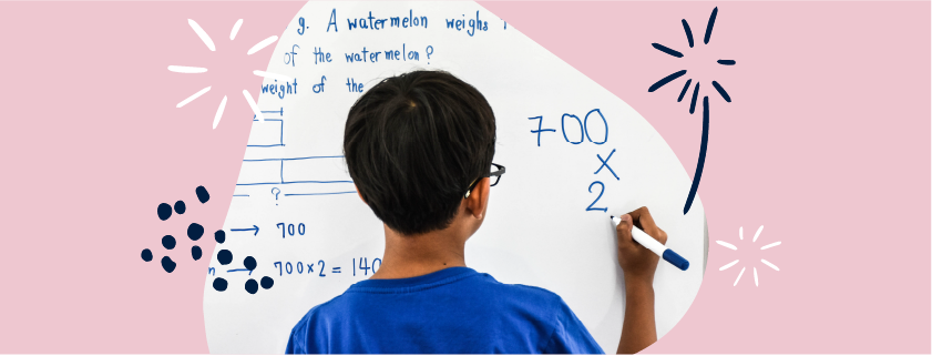 image of a boy solving a maths question on a whiteboard