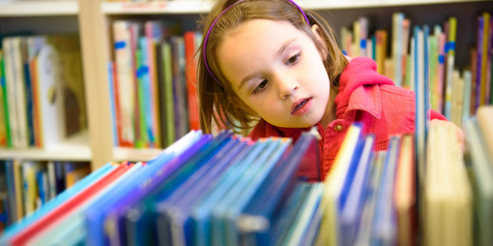 Image showing girl looking at books